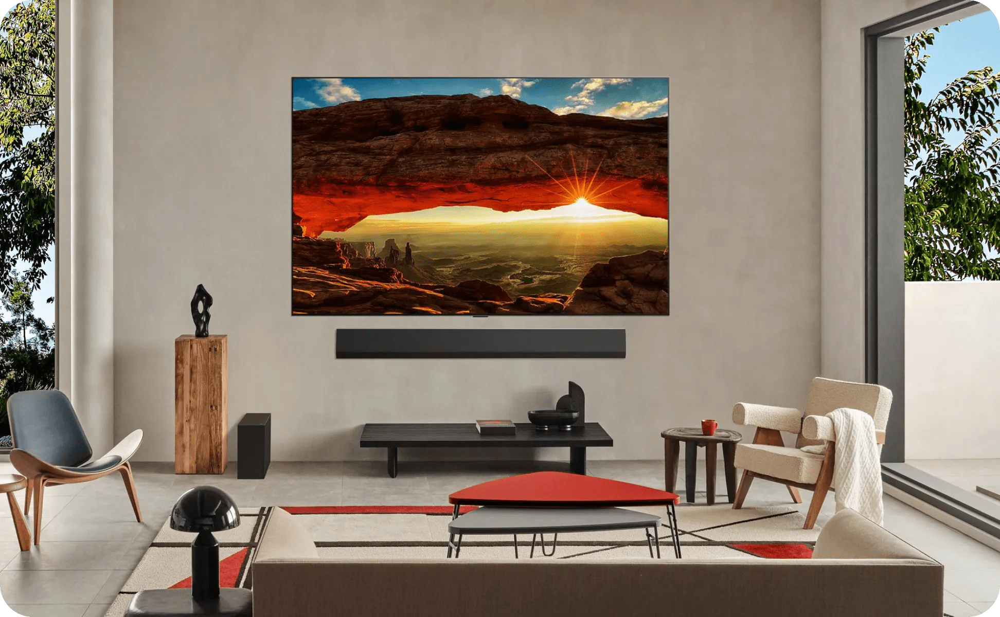 Cozy, neutral-toned room with large windows, LG TV shows bridge painting, paired with LG soundbar and subwoofer.