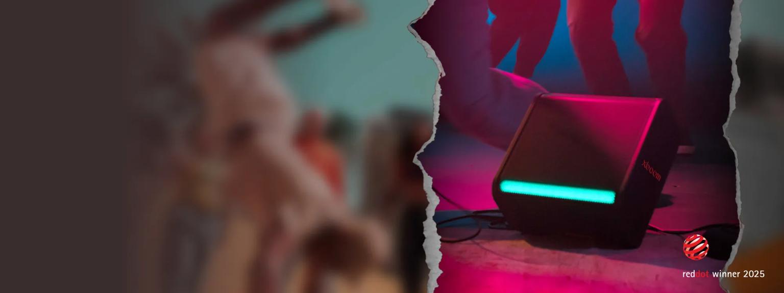 Closeup of xboom speaker. With “reddot winner 2025” badge.