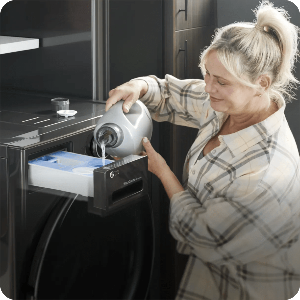 A woman fills the ezDispense™ reservoir with detergent.
