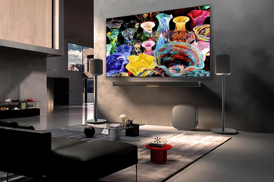 LG 86MRGB95BUA TV with Dolby Atmos Soundbar and wireless speakers in modern living room setup