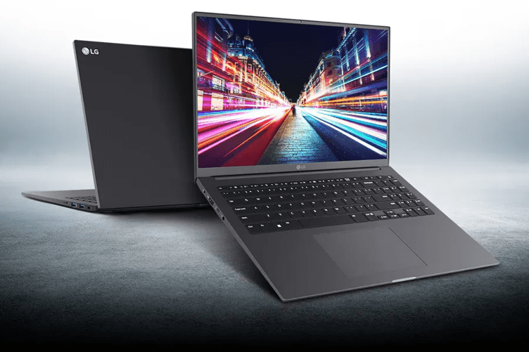 Two LG UltraPC laptops on a grey textured backdrop. The left rear laptop is facing away from the viewer, while the front right laptop is facing us to show a brightly colored high contrast image of a long-exposure nighttime city street.