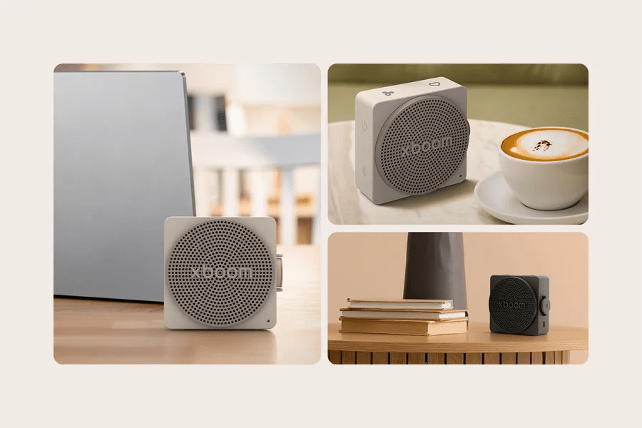 MINI_ANOALBK LG xboom portable speaker shown in white and black colors on tables with laptop, coffee cup, and books highlighting compact design