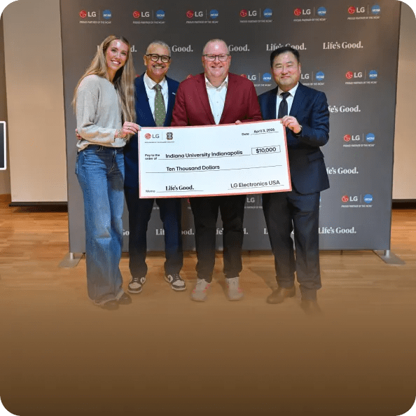 A photo from the 2026 NCAA Final Four shows an LG executive, an NAMI representative and Lexie Hull holding a $10,000 check for Indiana University Indianapolis.