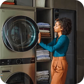 A woman opens the upper door of her LG WashTower™.