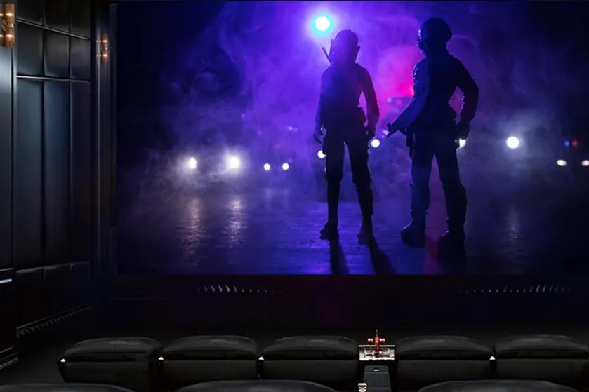 A small chic theater with an LG OLED 97 display showing a science fiction movie.