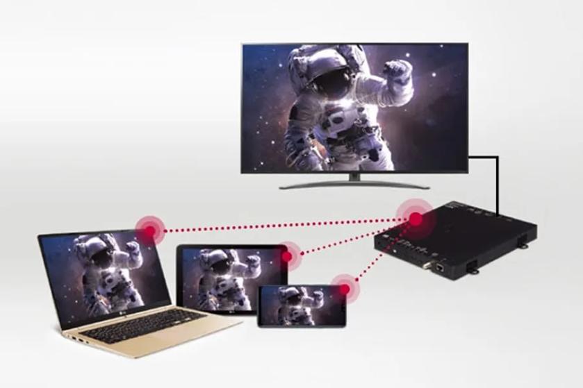 The image displays a set of multiple digital devices connected through a central set top box. At the top, there is a large flat-screen TV showing an astronaut in space. Below, three smaller screens (a laptop, a tablet, and a smartphone) also display the same astronaut image.