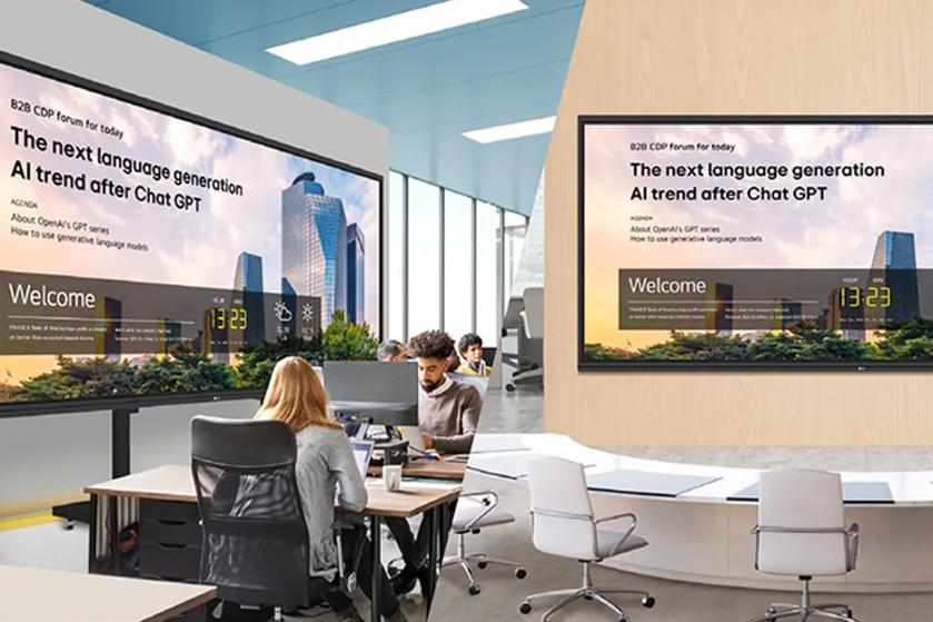 Office scene with large CreateBoard screens displaying content about an AI forum.