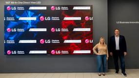 Two guests stand besides the All-in-One DVLED display at the LG Chicago BIC.